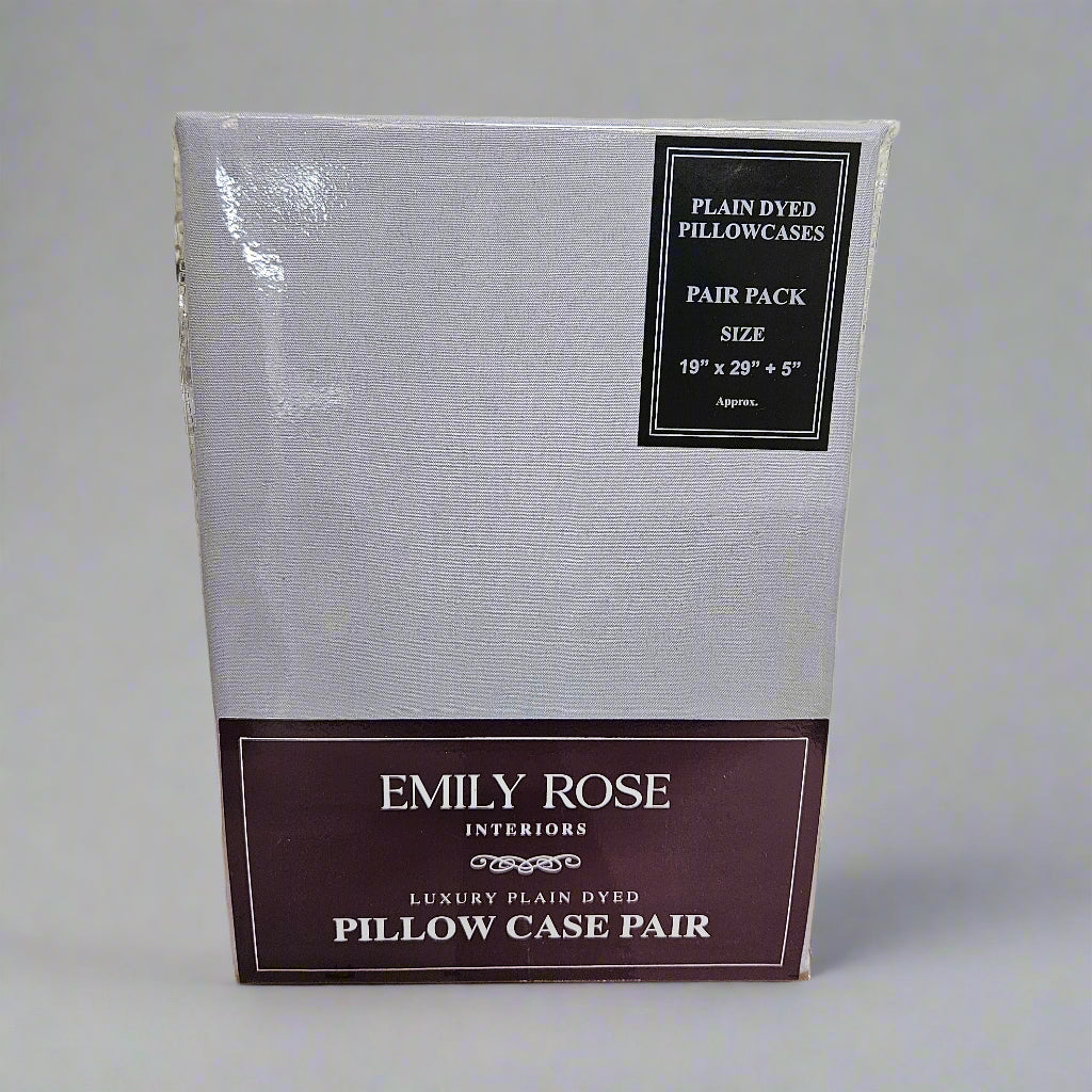 Packaged pillowcases with 'Emily Rose Interiors' branding on a textured surface.